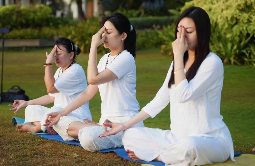 3 Yogics performing breathing techniques