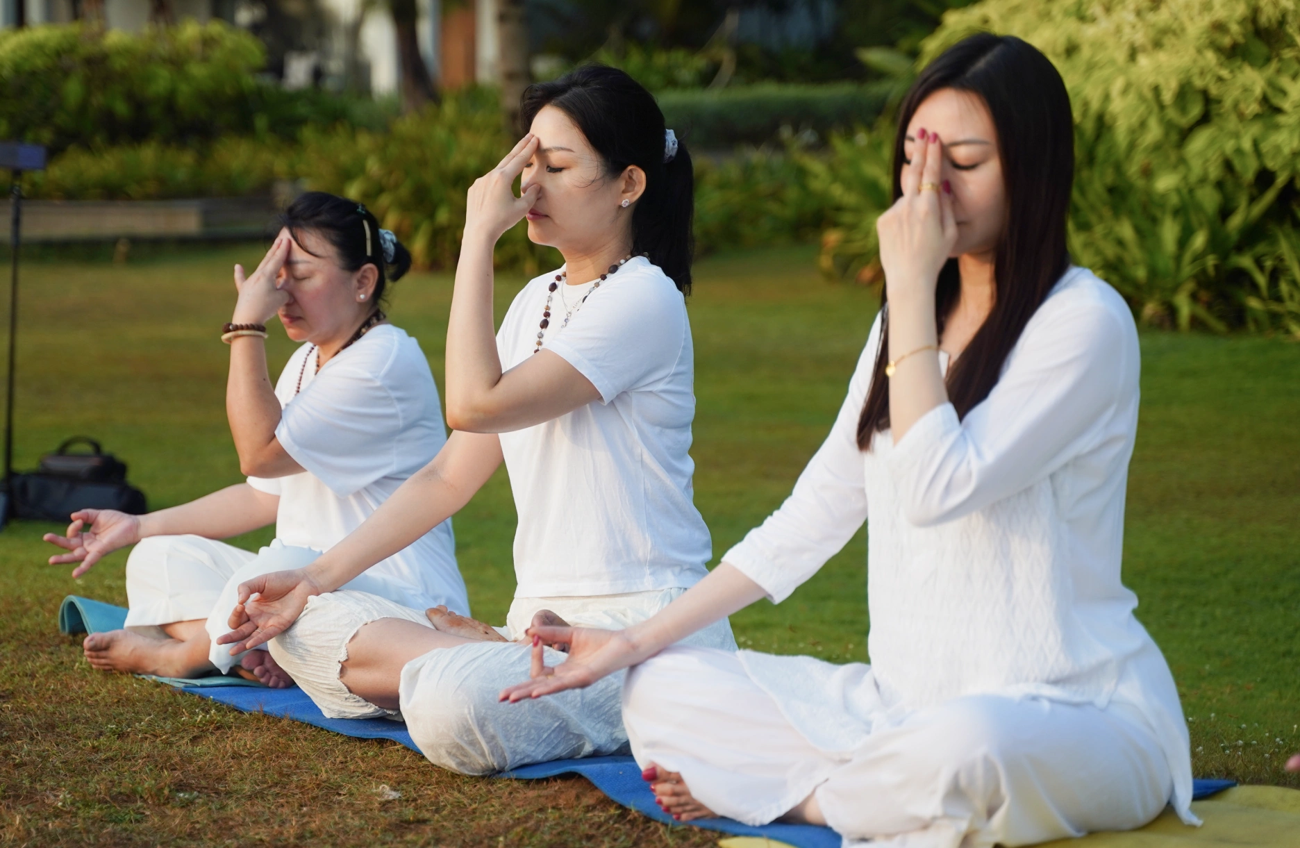 3 Yogics performing breathing techniques