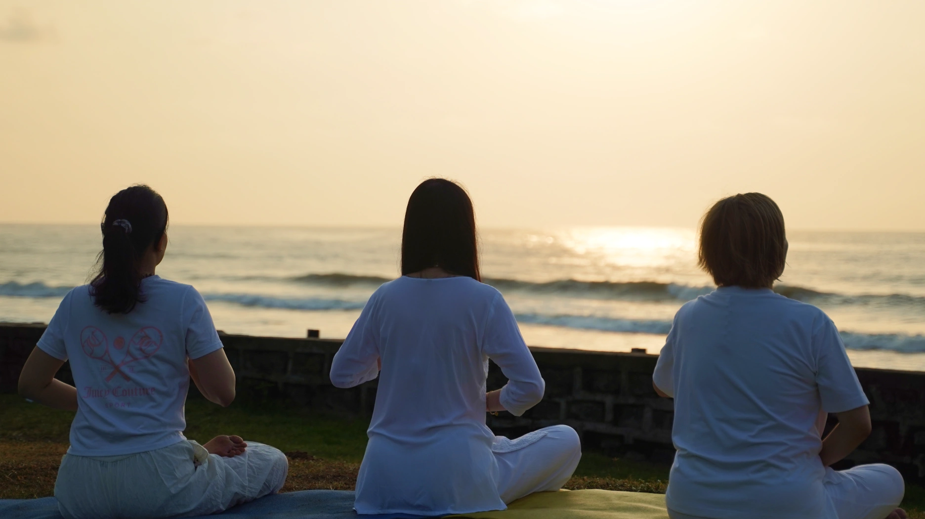 3 Person Performing Meditation on Sea Beach
